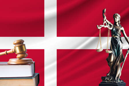Law and justice in Denmark. Statue of themis and the gavel of the judge against the background of the flag of Denmark.の写真素材