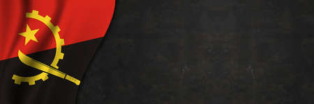 Angola flag on concrete wall. Banner with fabric texture of the flag of Angola.の写真素材