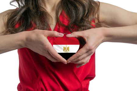 Love Egypt The woman holds a heart in the form of the flag of Egypt on her chest. Concept of patriotism.の写真素材