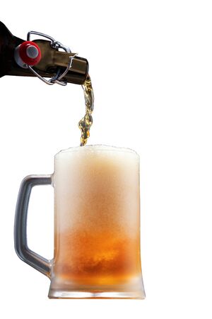 Pouring beer into a glass from the bottle, fresh foaming beer, isolatedの写真素材