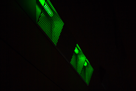 Abstract night lighting of the building facade with fluorescent lamps. Lights are in a metal case with holes.の写真素材