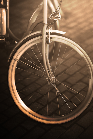 Front of the bike with white wheel. Chrome-plated metal lantern. The background is blurred.の写真素材