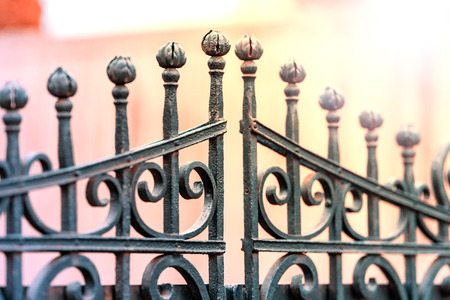 Wrought-iron fencing painted black with the decorations. The background is blurred. Shallow depth of field.の写真素材