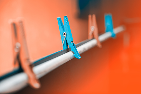 Clothespins in the photo the rack holds the background paper in black. Stock aluminum photo.の写真素材