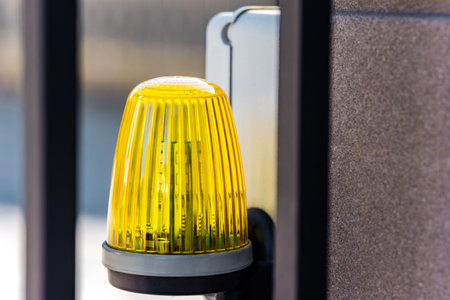 Lantern on the automatic gate warning of danger. The background is blurred. Shallow depth of field.