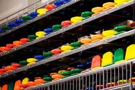 Seats for spectators on the Playground. The seats are made of plastic. The background is blurred.