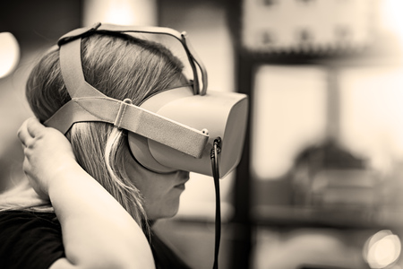 Girl with virtual Reality Glasses. Glasses are made of plastic. The background is blurred.の写真素材