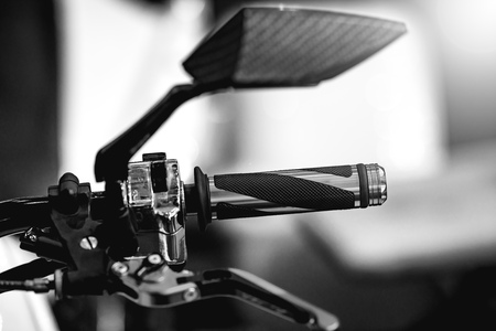 Shiny and clean ATV controls made of metal and rubber. Small details are visible. The background is blurred.の写真素材