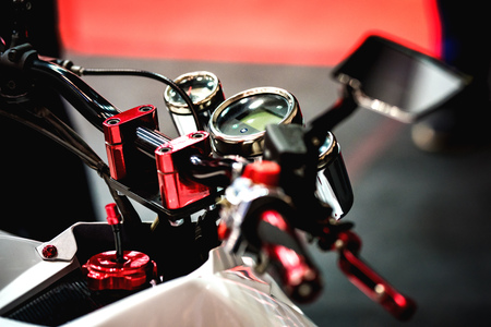 Shiny and clean ATV controls made of metal and rubber. Small details are visible. The background is blurred.の写真素材