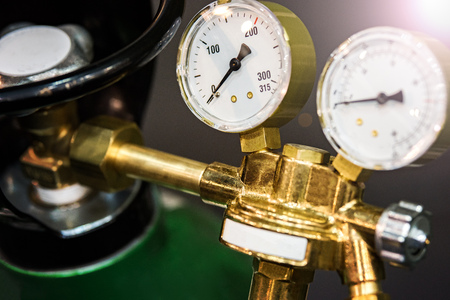 Gas new metal cylinders with pressure gauge. Small details are visible. The background is blurred.の写真素材