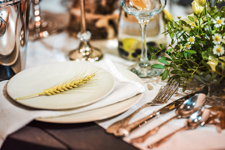 Festive dining table with flowers. Shallow depth of field. The background is blurred.の写真素材