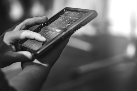 Touch tablet with stage speaker control panel. The tablet displays readings. The background is blurred.の写真素材