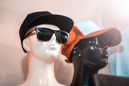 Plastic mannequins with cap. Mannequins are simple without drawing eyes. The background is blurred.