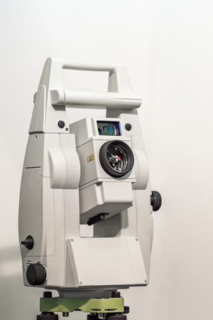 Electronic optical measuring device in white. Has the lens and viewfinder. The background is gray and blurred.の写真素材