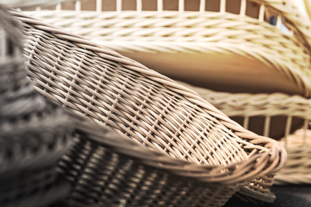 Lots of new wicker baskets. Shallow depth of field. The background is blurred.