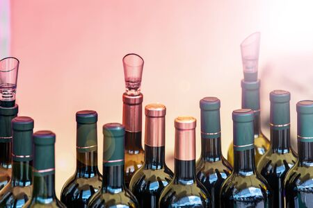 Many bottles of alcohol and stale drinks closed lids and stoppers. The background is blurred.の写真素材