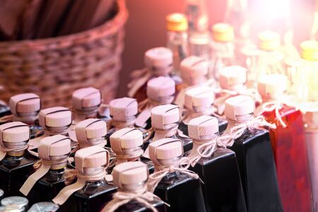 Many bottles of alcohol and stale drinks closed lids and stoppers. The background is blurred.の写真素材