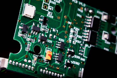 A close-up microchip with many electrical components placed on the Board. The background is blurred.の写真素材