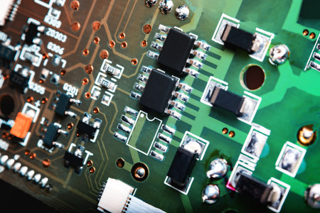 A close-up microchip with many electrical components placed on the Board. The background is blurred.