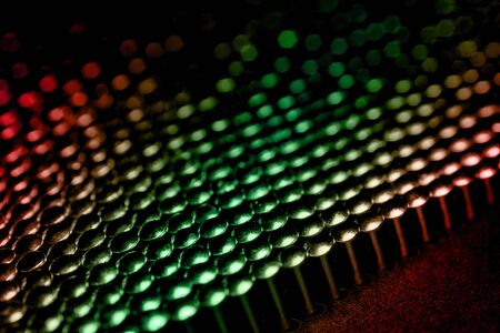 A lot of shiny little nails on a dark background arranged tightly together. Shallow depth of field.の写真素材