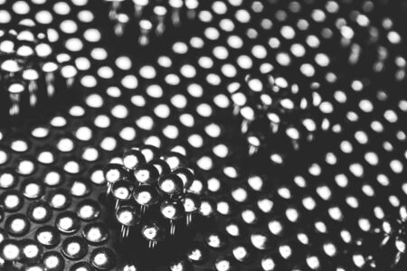 A lot of shiny little nails on a dark background arranged tightly together. Shallow depth of field.の写真素材