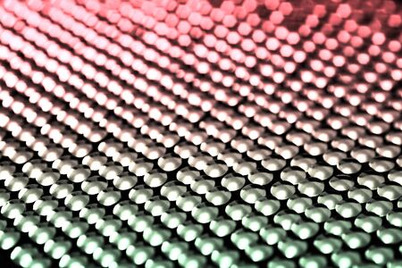 Lots of shiny little studs on a dark background arranged tightly together. Shallow depth of field.の写真素材