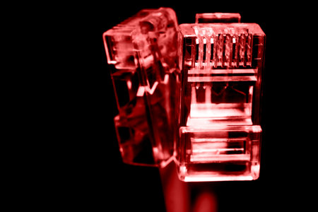 Several network Internet connectors on a black background shot in macro mode. Visible metal...