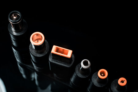 Several electro connectors on a black background shot in macro mode. Visible metal connectors of...