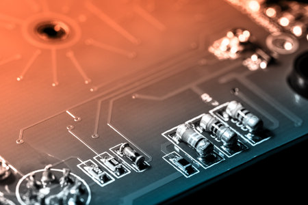 A close-up microchip with many electrical components placed on the Board. The background is blurred.
