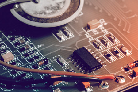 A close-up microchip with many electrical components placed on the Board. The background is blurred.