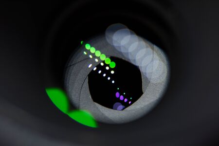 Scale of the photo lens. The black lens is made of metal and plastic. Shallow depth of field.の写真素材