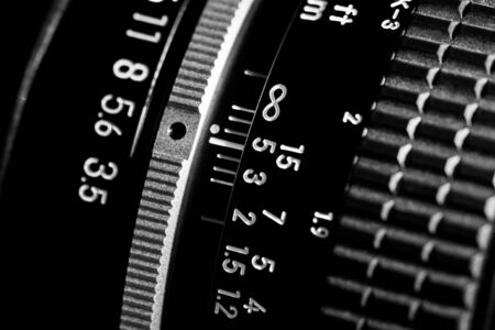 Scale of the photo lens. The black lens is made of metal and plastic. Shallow depth of field.の写真素材