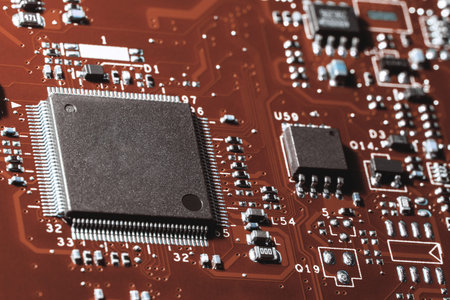 A close-up microchip with many electrical components placed on the Board. The background is blurred.