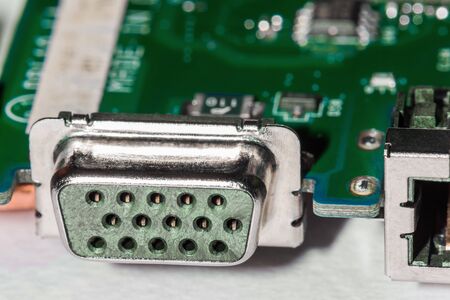 A close-up microchip with many electrical components placed on the Board. The background is blurred.の写真素材