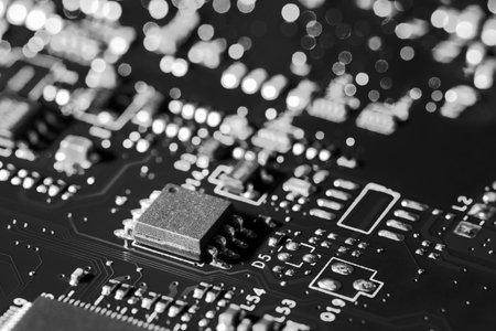 A close-up microchip with many electrical components placed on the Board. The background is blurred.の写真素材