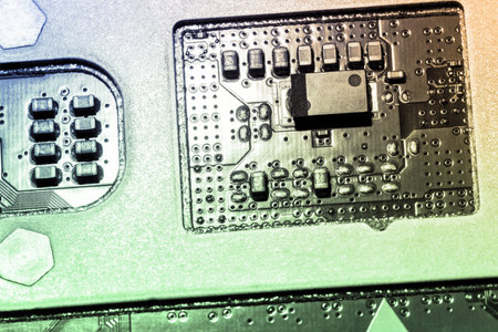 A close-up microchip with many electrical components placed on the Board. The background is blurred.