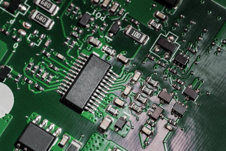 A close-up microchip with many electrical components placed on the Board. The background is blurred.