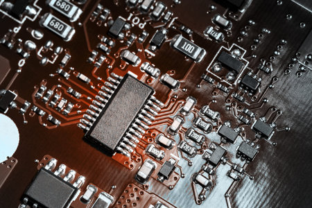 A close-up microchip with many electrical components placed on the Board. The background is blurred.