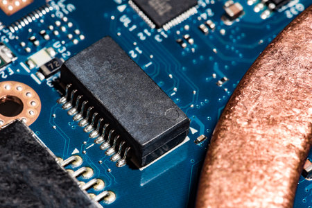 A close-up microchip with many electrical components placed on the Board. The background is blurred.
