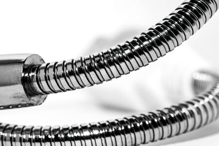 Metal flexible tube retainer for electrical appliances. Low depth of field. The background is light.の写真素材
