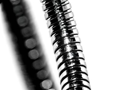 Metal flexible tube retainer for electrical appliances. Low depth of field. The background is light.の写真素材