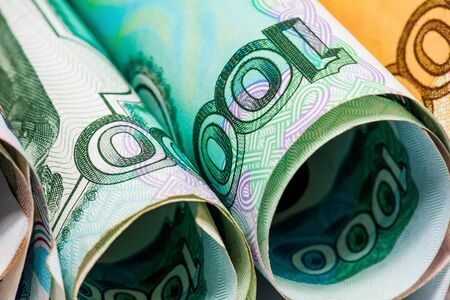 Rolled banknote of rubles of different denominations on a white background photographed close.の写真素材