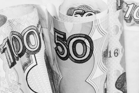 Rolled banknote of rubles of different denominations on a white background photographed close.の写真素材