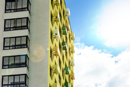 Multistorey new large apartment built of reinforced concrete. Under some Windows there is a platform...