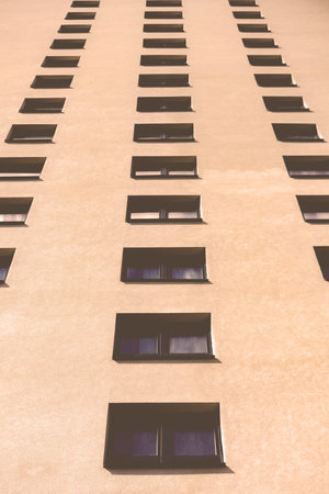 Multistorey new large apartment built of reinforced concrete. Under some Windows there is a platform...