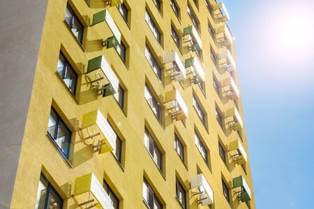 Multistorey new large apartment built of reinforced concrete. Under some Windows there is a platform for air conditioners.の写真素材