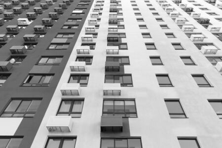 Multistorey new large apartment built of reinforced concrete. Under some Windows there is a platform for air conditioners.の写真素材