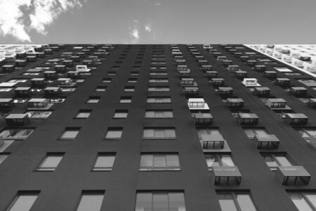 Multistorey new large apartment built of reinforced concrete. Under some Windows there is a platform for air conditioners.の写真素材