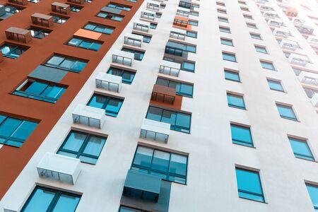 Multistorey new large apartment built of reinforced concrete. Under some Windows there is a platform for air conditioners.の写真素材