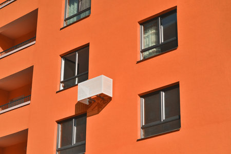 Multistorey new large apartment built of reinforced concrete. Under some Windows there is a platform...